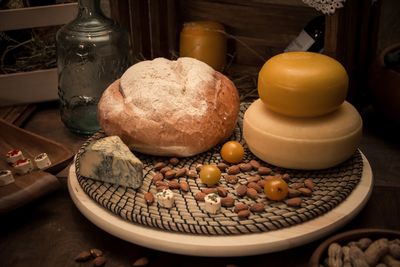 Bread with almonds in plate on table