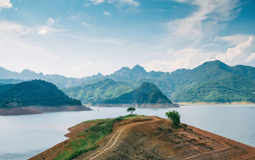 Scenic view of lake and mountains against sky