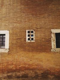 Low angle view of brick wall with windows