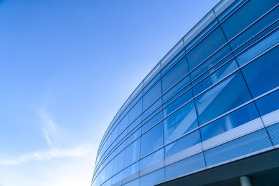 Low angle view of modern building against blue sky