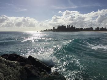 Scenic view of sea against cloudy sky