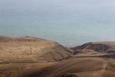 High angle view of land and sea against sky