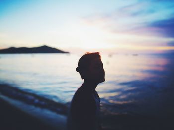 Woman on beach at sunset