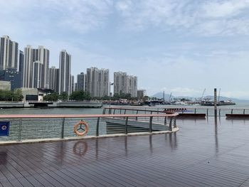 View of modern buildings against cloudy sky