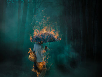 Digital composite image of woman standing against illuminated lights at night