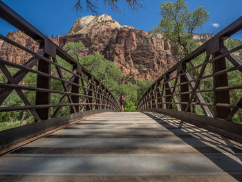 View of footbridge against mountain