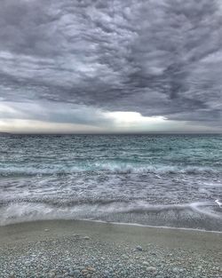 Scenic view of sea against dramatic sky