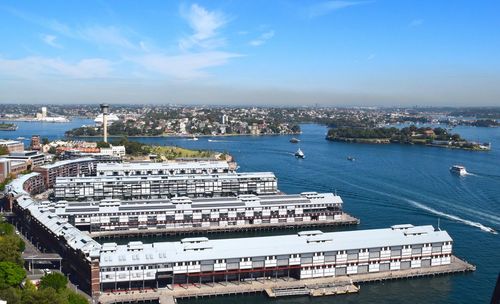 High angle view of cityscape by sea against sky