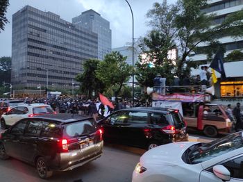 Traffic on city street by buildings