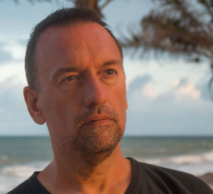 Close-up of thoughtful man standing at beach