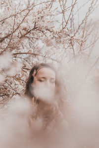 Portrait of woman against trees