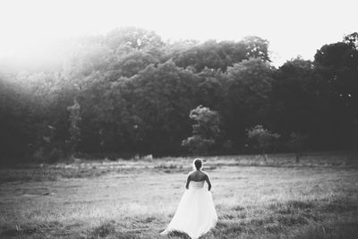 Bride walking through a field