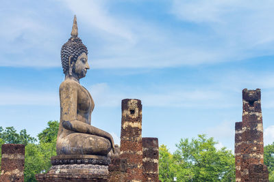 Statue of temple against cloudy sky