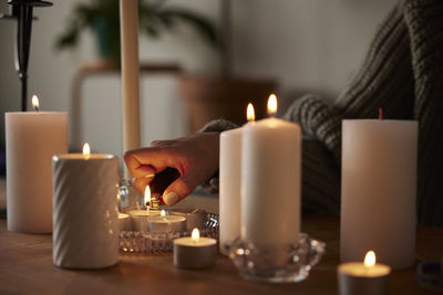 Woman lighting candles at home