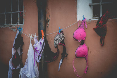 Pink toys hanging against wall