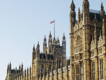 Low angle view of flags against buildings in city