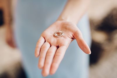 High angle view of wedding rings on palm