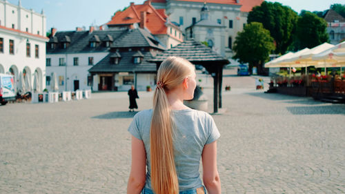 Portrait of young woman standing on street