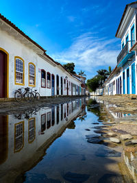 Reflection of building in puddle in city