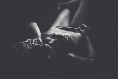 Seductive woman lying in darkroom