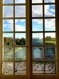 Trees and buildings seen through glass window