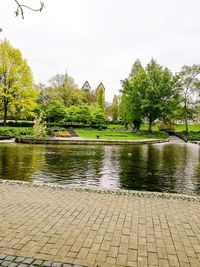 Scenic view of lake in park against sky