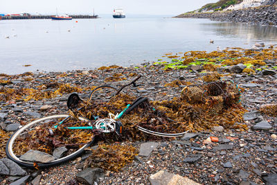 Abandoned bicycle on a rocky beach