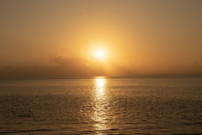 Scenic view of sea against sky during golden sunset on summer in okinawa japan 