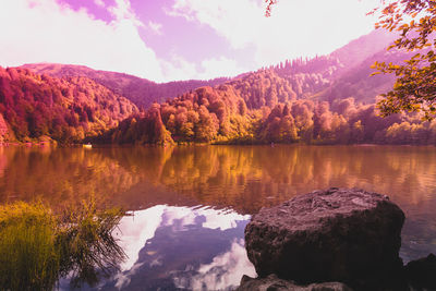 Scenic view of lake and mountains against sky