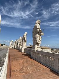 Statue of historic building against cloudy sky