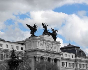 Low angle view of statue against cloudy sky
