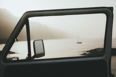 Scenic view of sea seen through car window