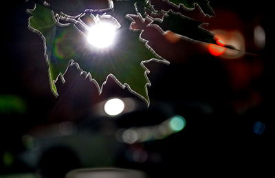 Low angle view of illuminated lights at night