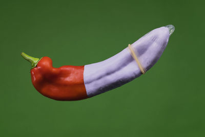 Close-up of red chili pepper against white background