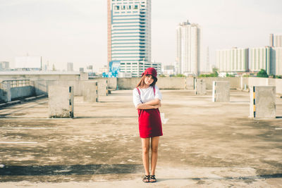 Full length portrait of woman standing in city