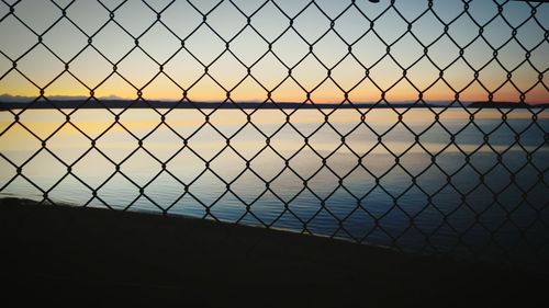 Close-up of chainlink fence against clear sky