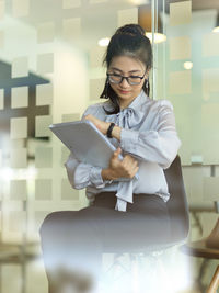 Young woman sitting in office