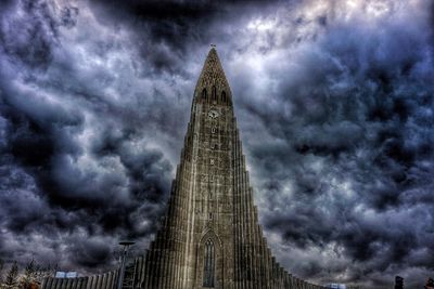 Low angle view of tower against cloudy sky