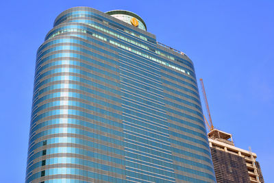 Low angle view of modern building against blue sky