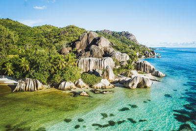 Aerial photo of seychelles tropical beach anse source d'argent in evening light at la digue island