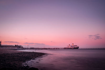 Scenic view of sea against romantic sky at sunset