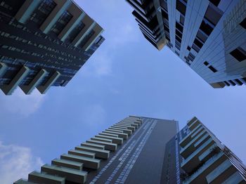 Low angle view of modern buildings against sky in city