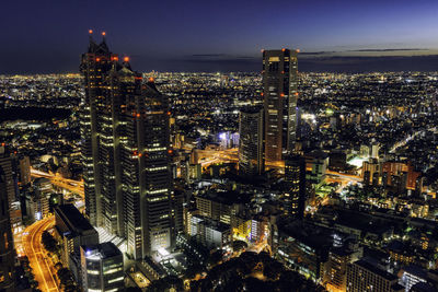 High angle view of illuminated city buildings at night