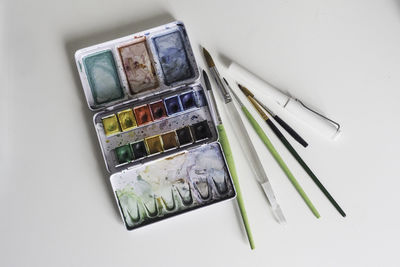 High angle view of objects on table against white background