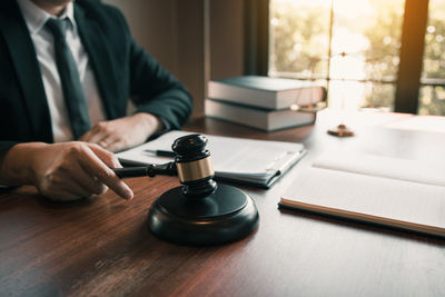 Midsection of man using laptop on table