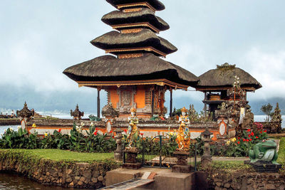 Temple by building against sky