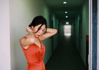 Full length of woman standing in corridor