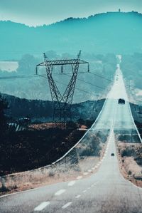 Double exposure of road by mountain against sky