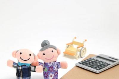 Close-up of toys on table against white background