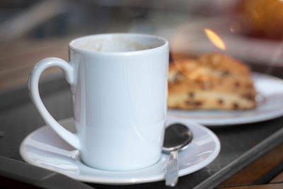 Porcelain cup with coffee on a tablet. mock up offers space for your own designs. 